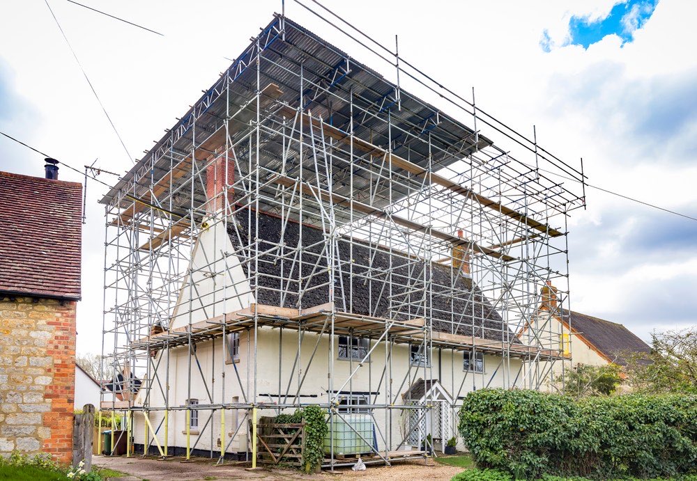 Scaffolding and a temporary roof over a house during major renovation work